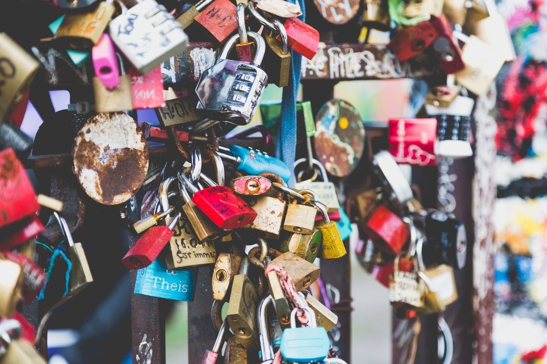 assorted padlocks hanged on wire